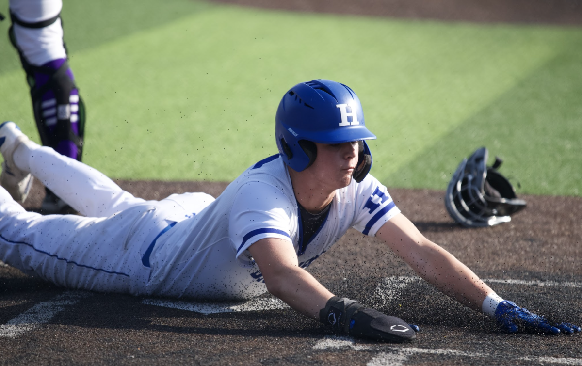 Teddy Krieg (10) slides into home base to score for the birds.